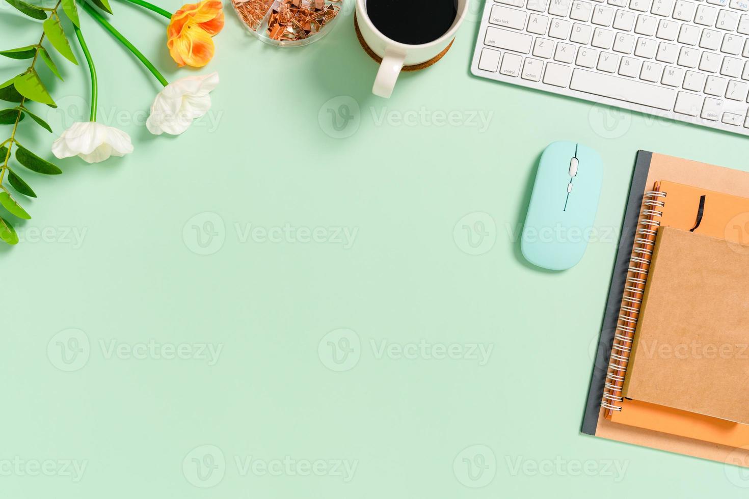 Minimal work space - Creative flat lay photo of workspace desk. Top view office desk with keyboard, mouse and notebook on pastel green color background. Top view with copy space, flat lay photography.
