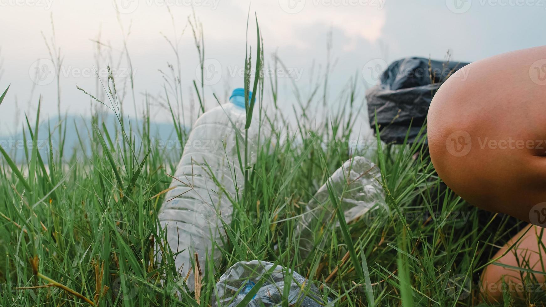 Happy young Asia activists collecting plastic waste on the forest. Korean lady volunteers help to keep nature clean up and pick up garbage. Concept about environmental conservation pollution problems. photo