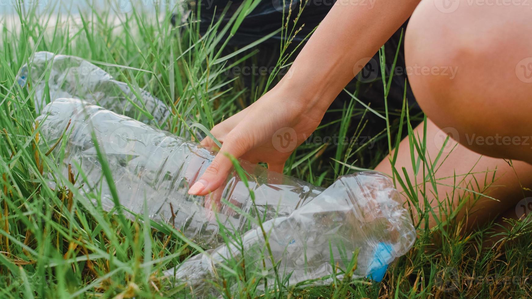 Happy young Asia activists collecting plastic waste on the forest. Korean lady volunteers help to keep nature clean up and pick up garbage. Concept about environmental conservation pollution problems. photo