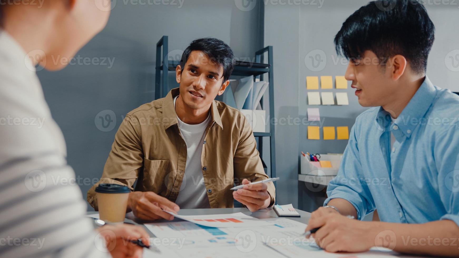 Happy young Asia businessmen and businesswomen meeting brainstorming some new ideas about project to his partner working together planning success strategy enjoy teamwork in small modern home office. photo