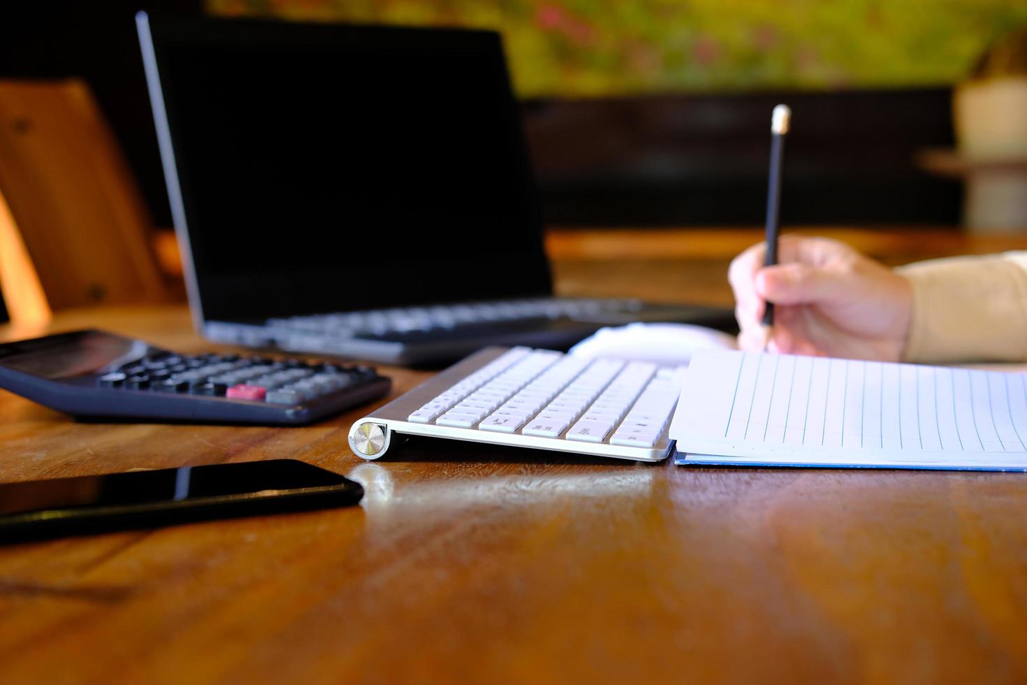 Man hand working on laptop computer on table and home quarantine, new normal photo