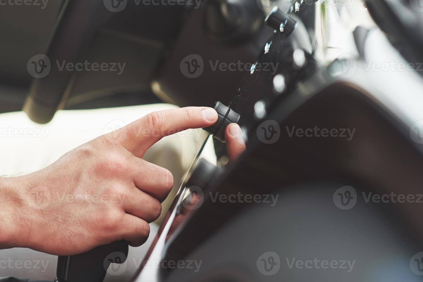 Man includes an audio system in the car. photo