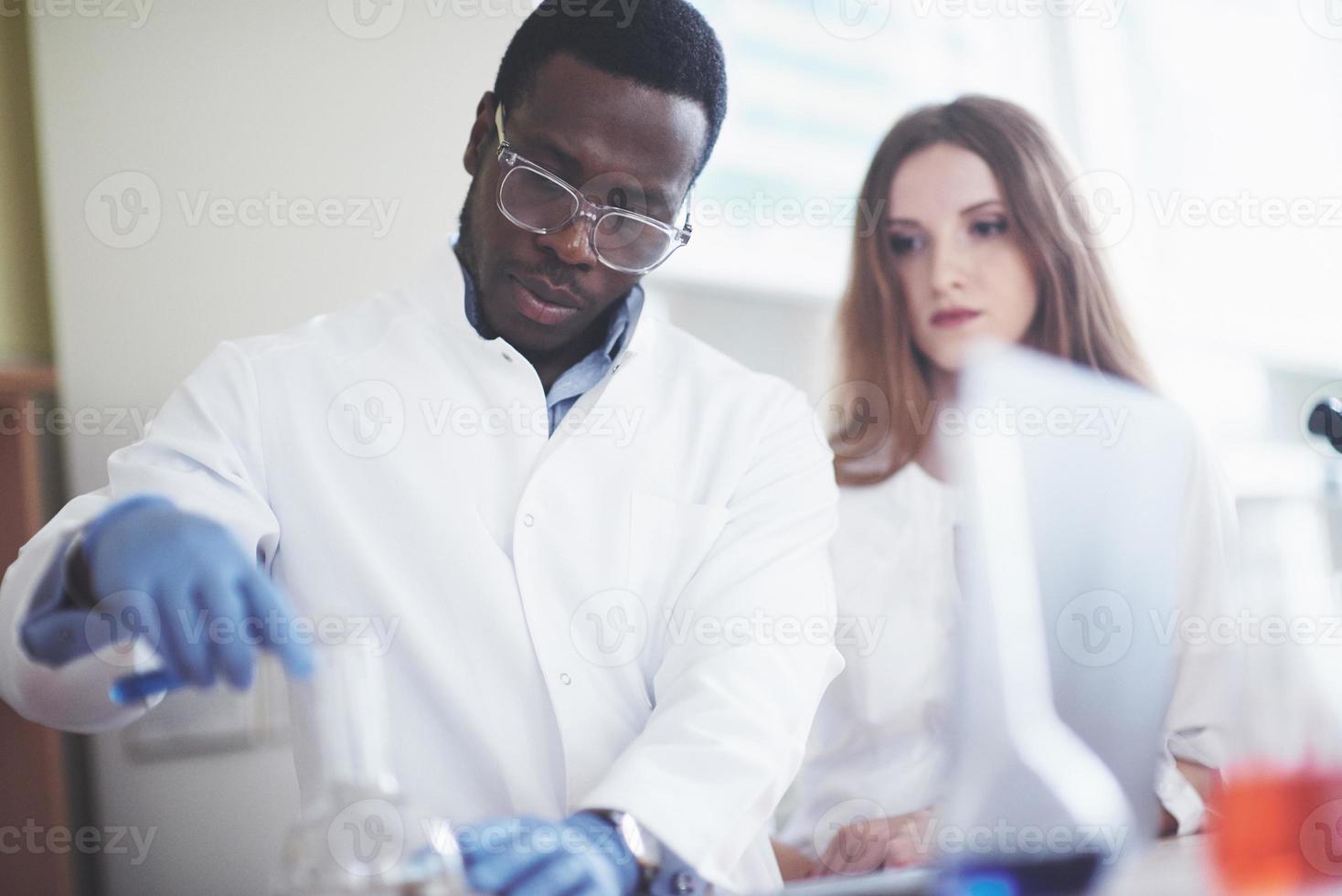 Laboratory laboratories conduct experiments in a chemical laboratory in transparent flasks. Output formulas photo