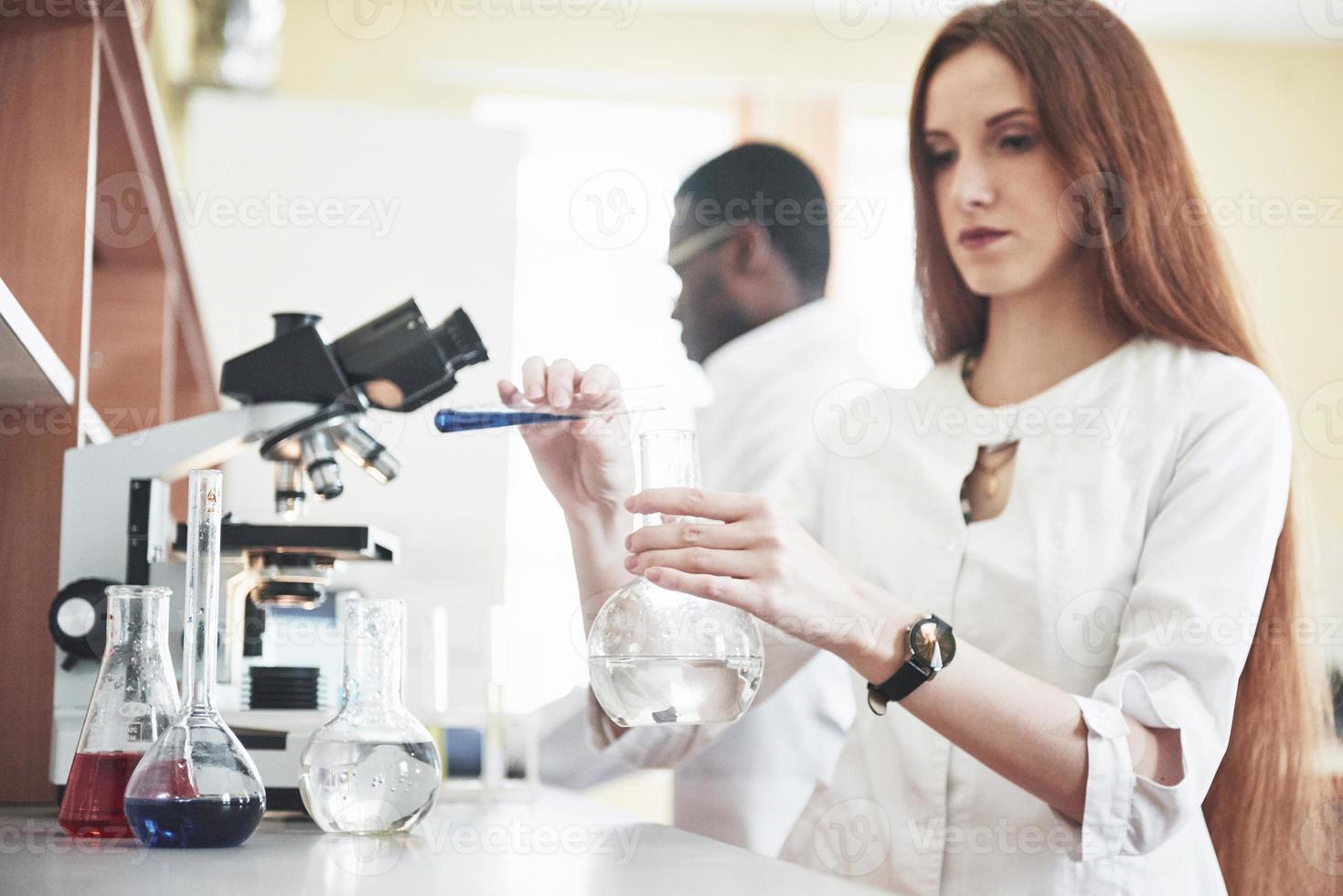 Laboratory laboratories conduct experiments in a chemical laboratory in transparent flasks. Output formulas photo