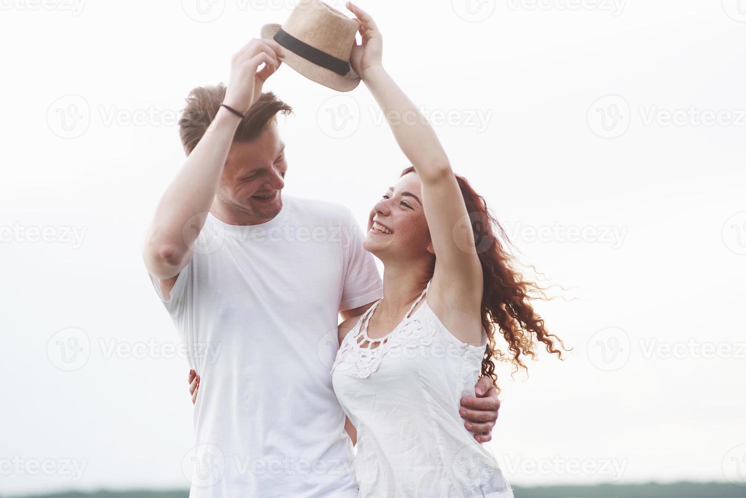 Young girl with hat and boy on summer sunny day photo