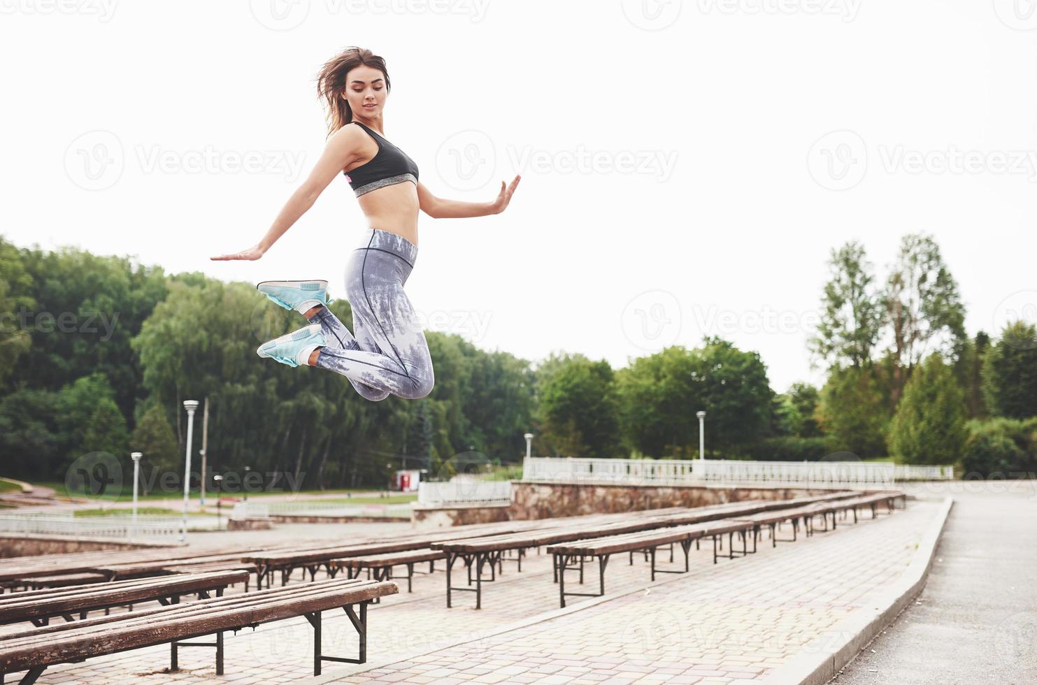 Woman doing parkour in the city on a sunny day photo