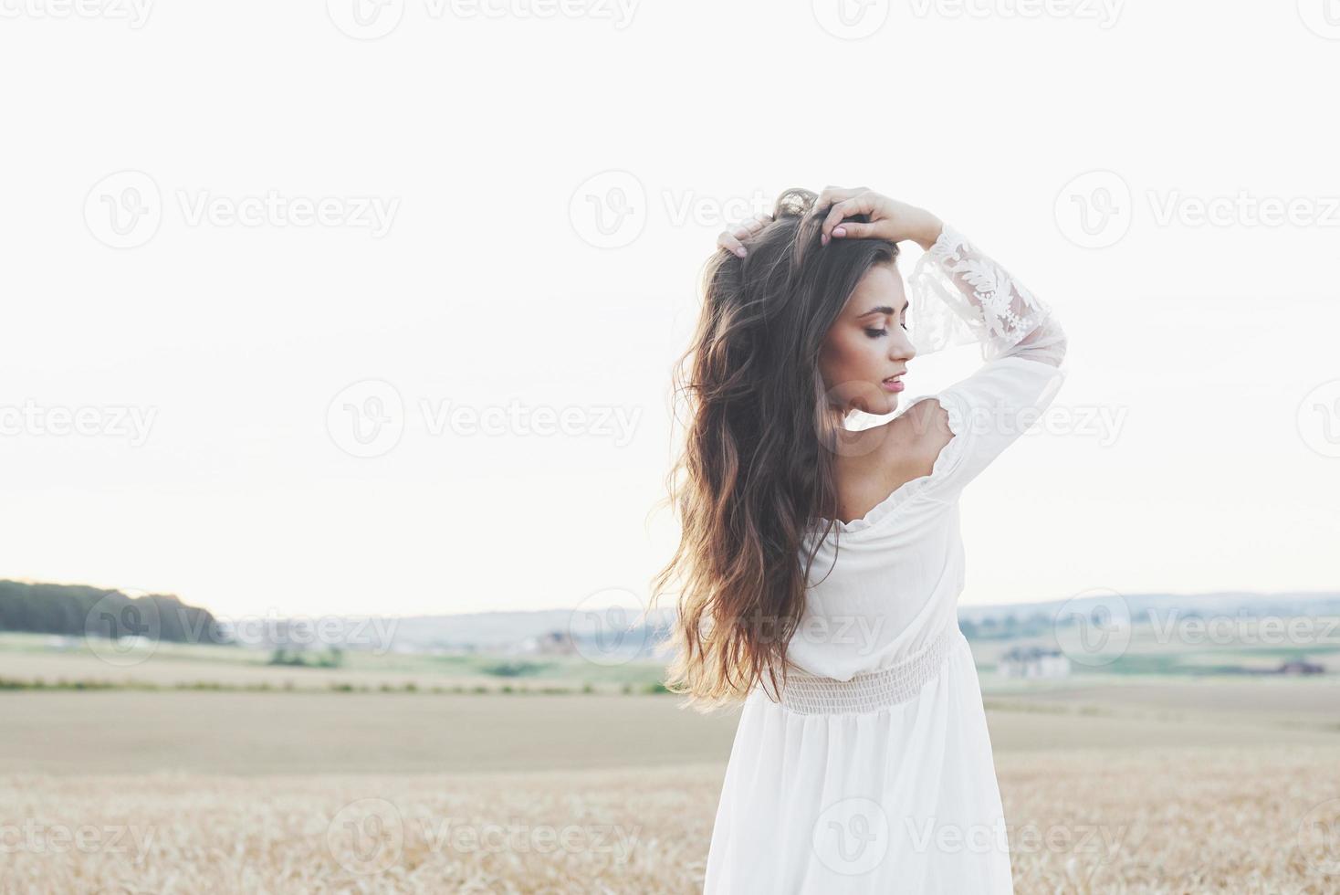 Beautiful girl in a field of wheat in a white dress, a perfect picture in the style lifestyle photo