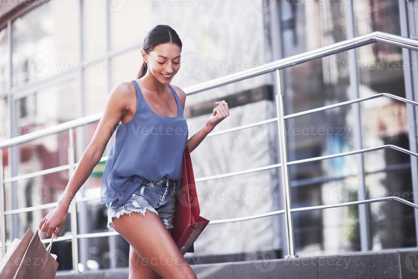 Attractive cute girl in with the bags enjoying in shopping. Favorite activity of all women photo