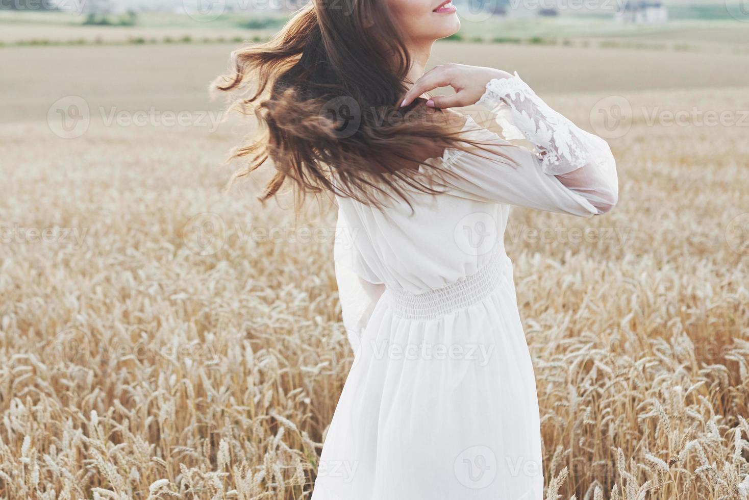 Beautiful girl in a field of wheat in a white dress, a perfect picture in the style lifestyle photo