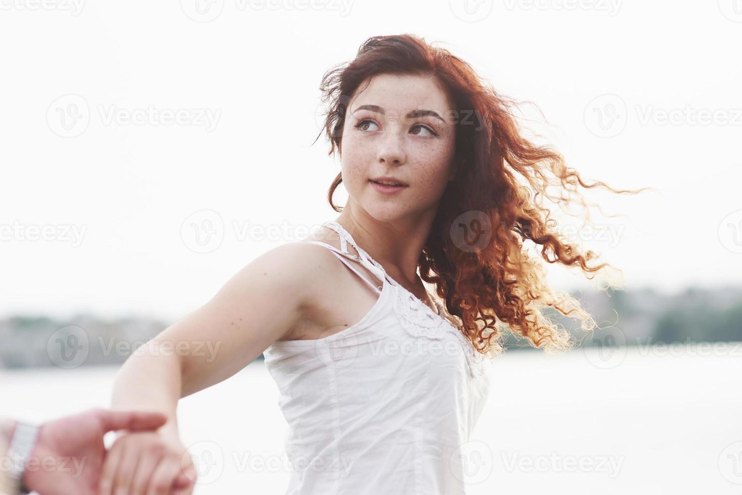 Beautiful girl holding her boyfriend's hand. photo