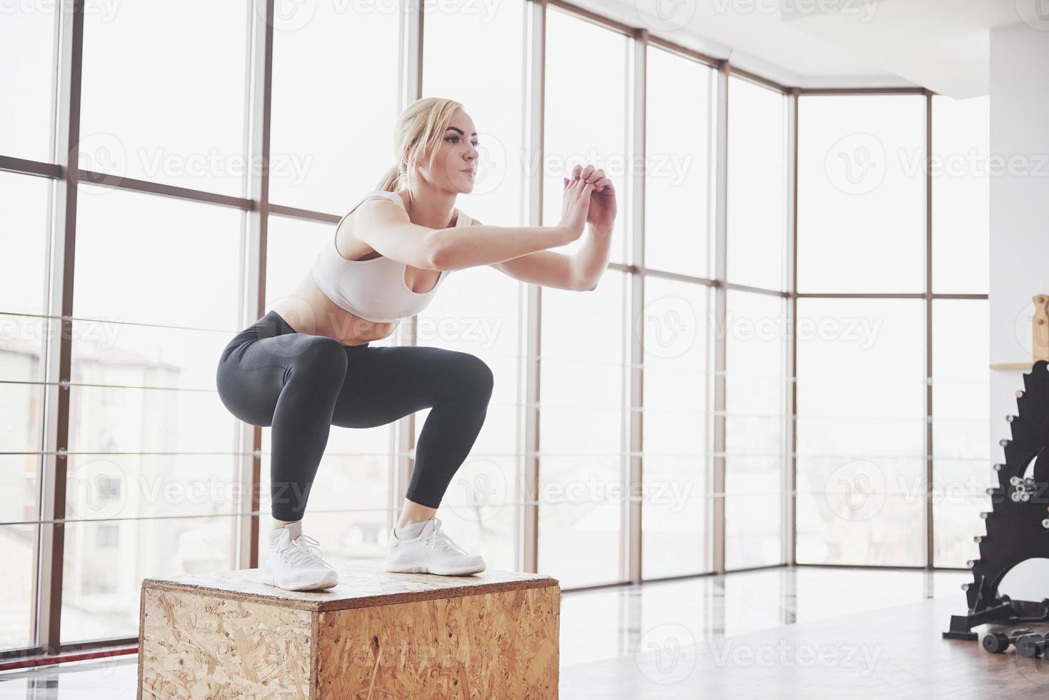 Woman lifting weights in gym Concept workout healthy lifestyle sport photo