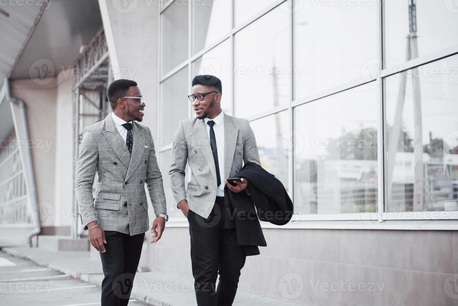 Business communication. Two cheerful business men talking to each other and discussing a project photo