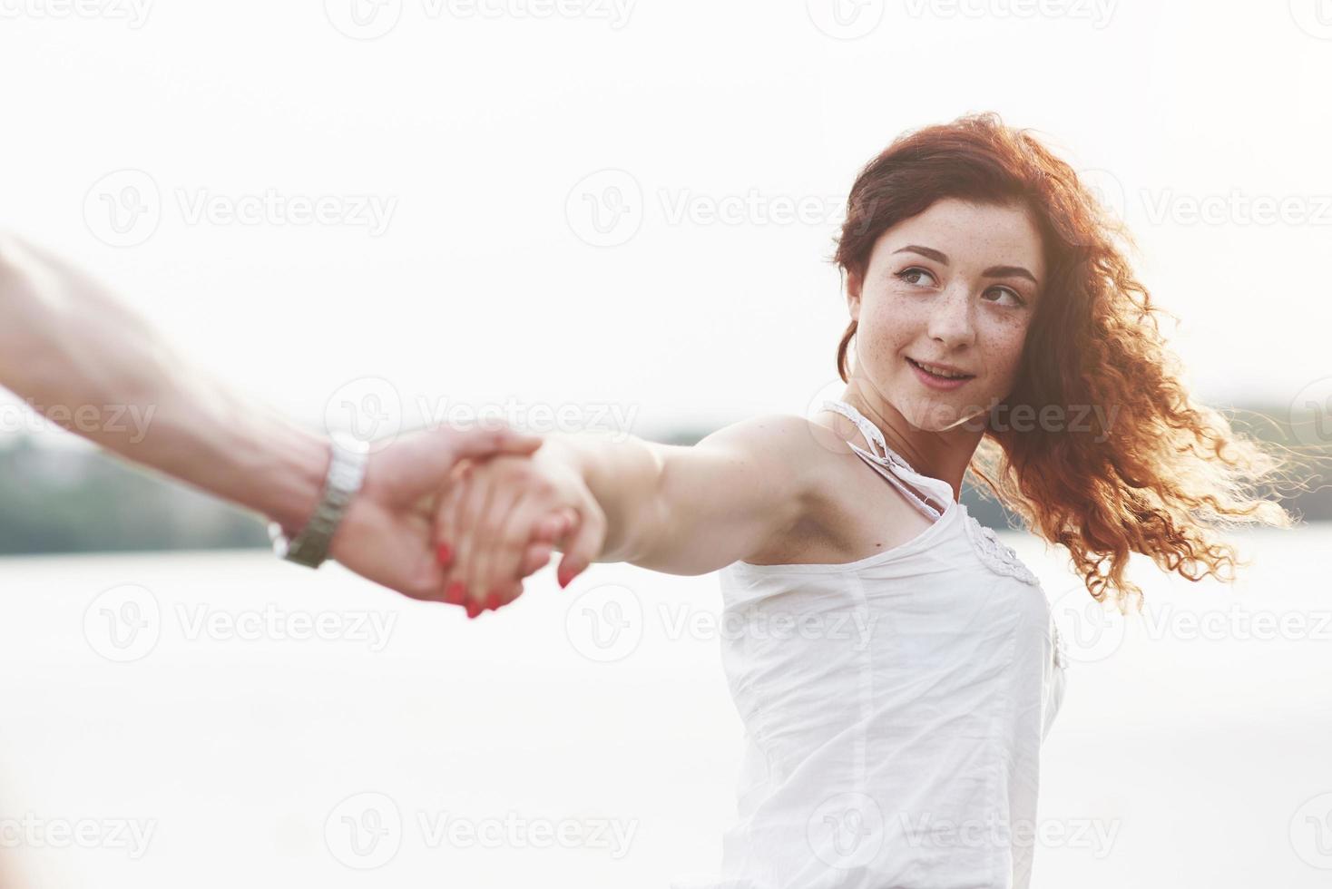 Beautiful girl holding her boyfriend's hand. photo