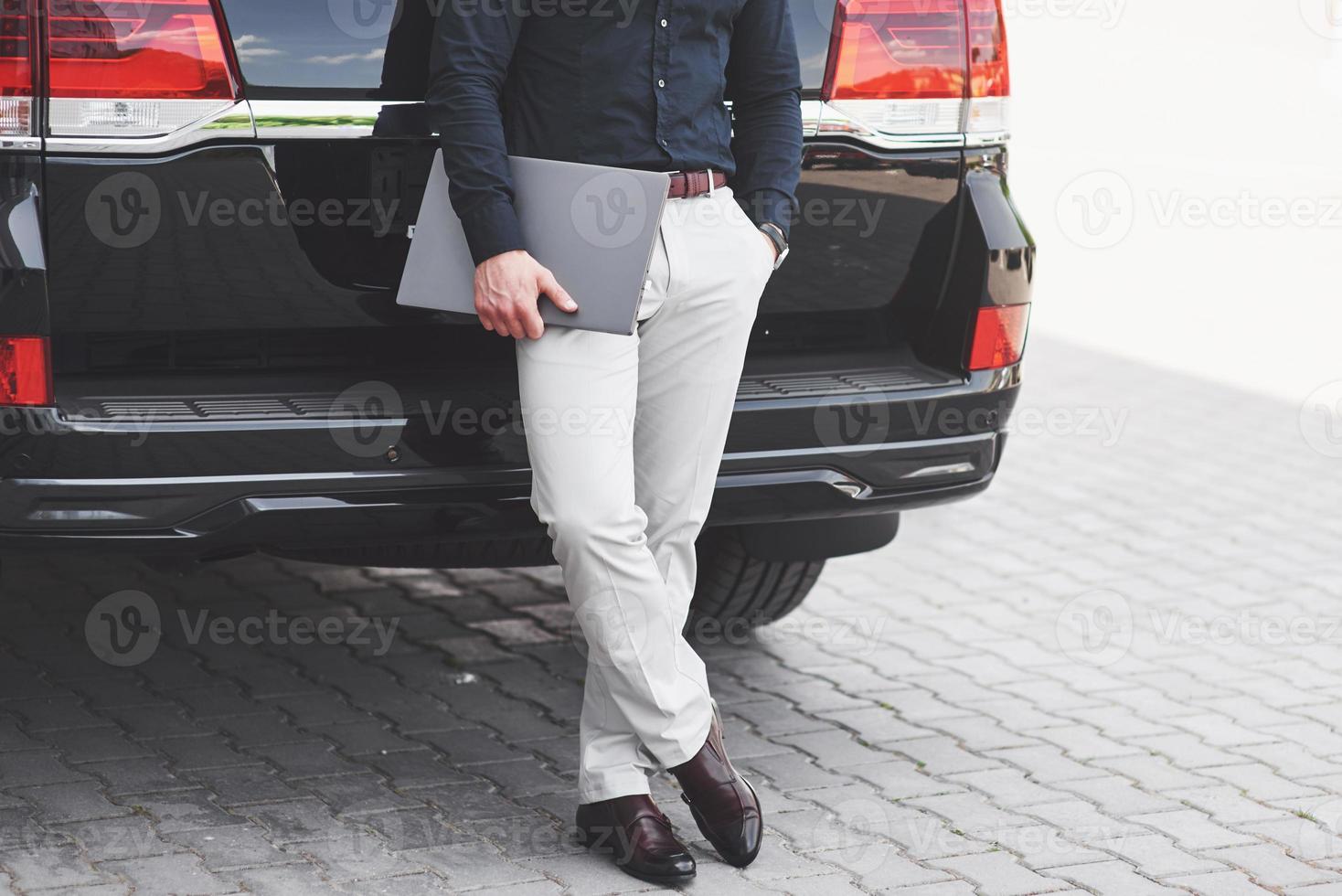 Portrait of a beautiful man in business clothes standing outside in the office. photo