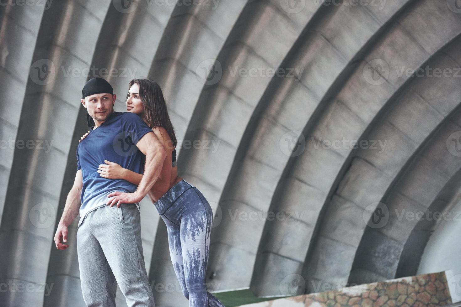 una pareja de deportes descansando después de un entrenamiento es una mujer sexy y un hombre. foto