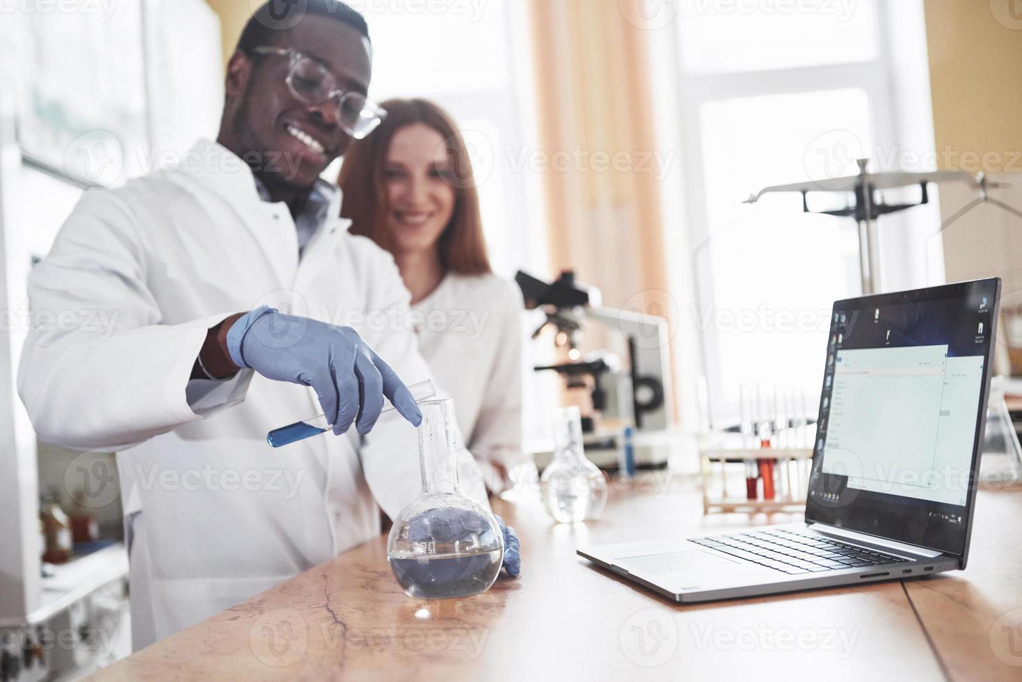 Laboratory laboratories conduct experiments in a chemical laboratory in transparent flasks. Output formulas photo