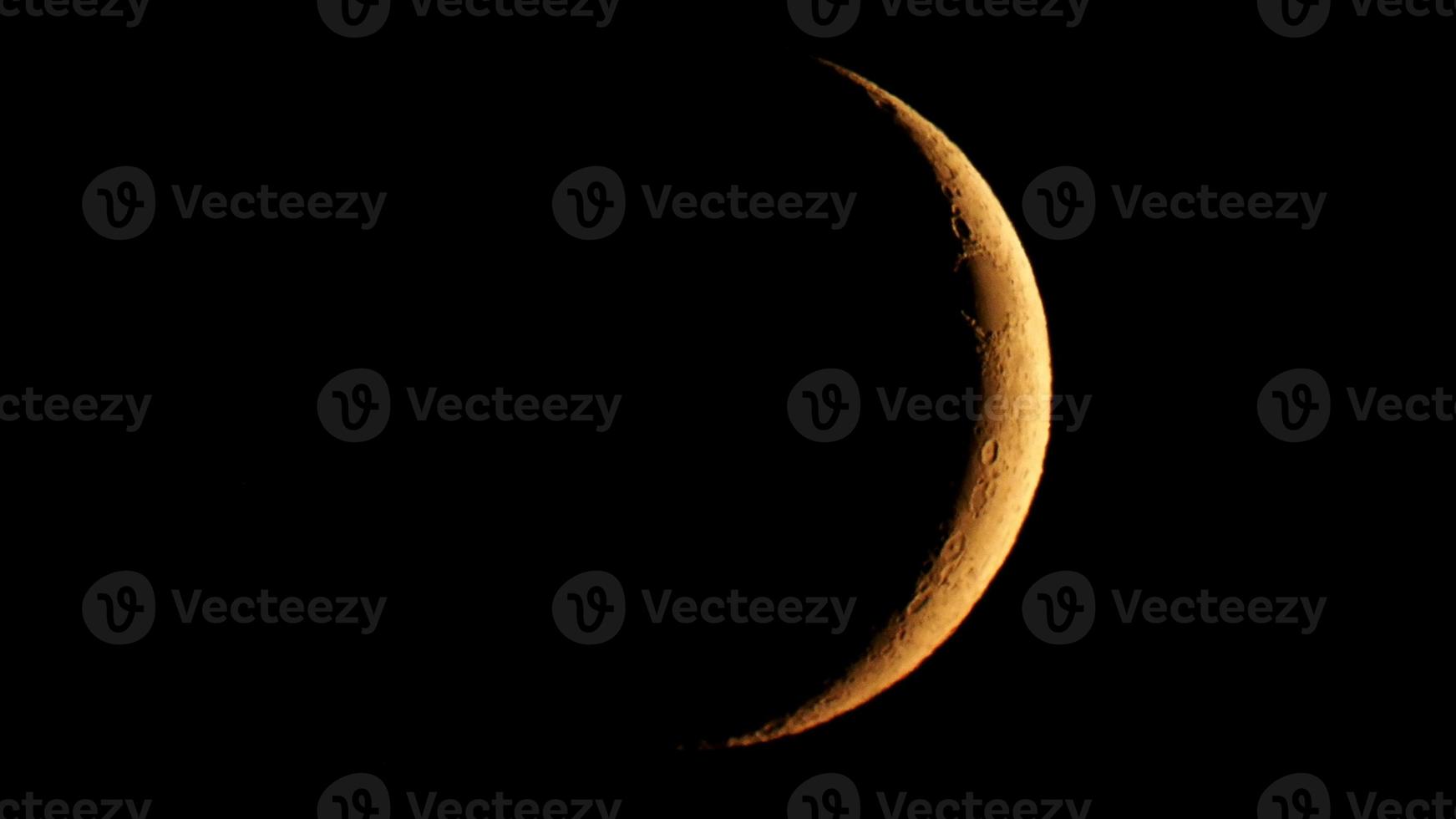 Waxing crescent moon seen with telescope photo