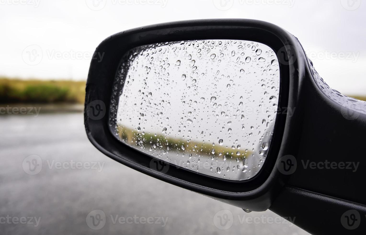 Rear view mirror with raindrops photo