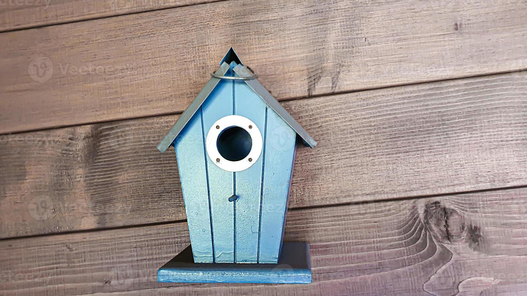 Bird houses in the interior of the cottage. Cups on the wall for decoration. photo