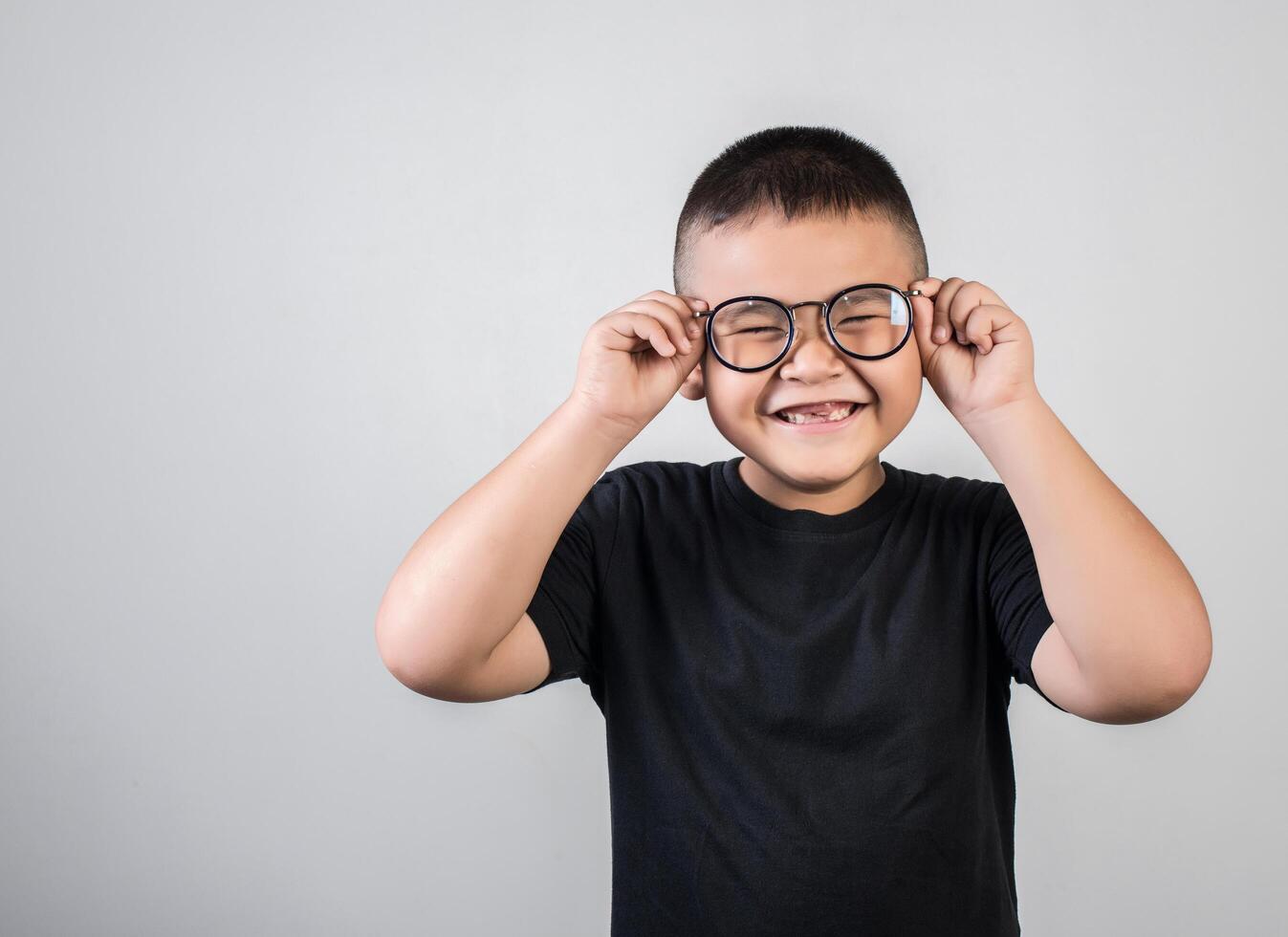 Funny boy genius wearing glasses in studio shot photo