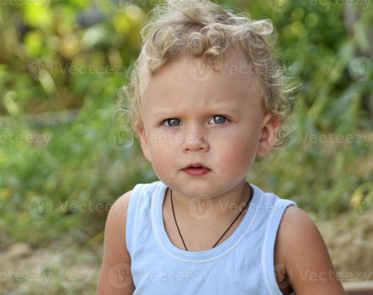 Beautiful baby boy with child face posing photographer for color photo