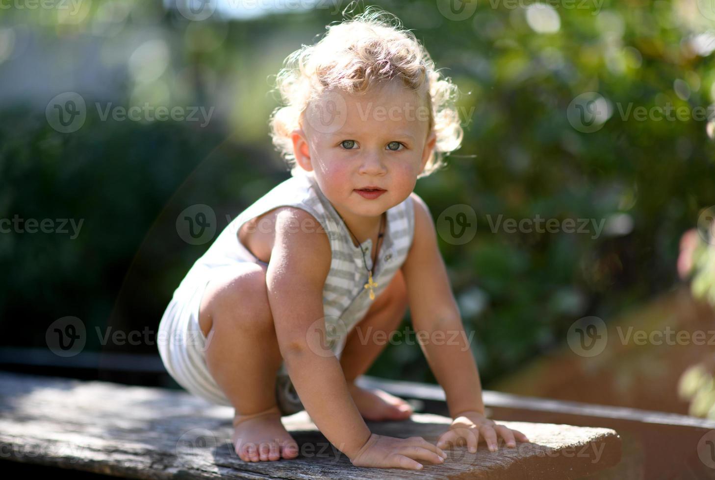 Beautiful baby boy in child garden posing photographer photo