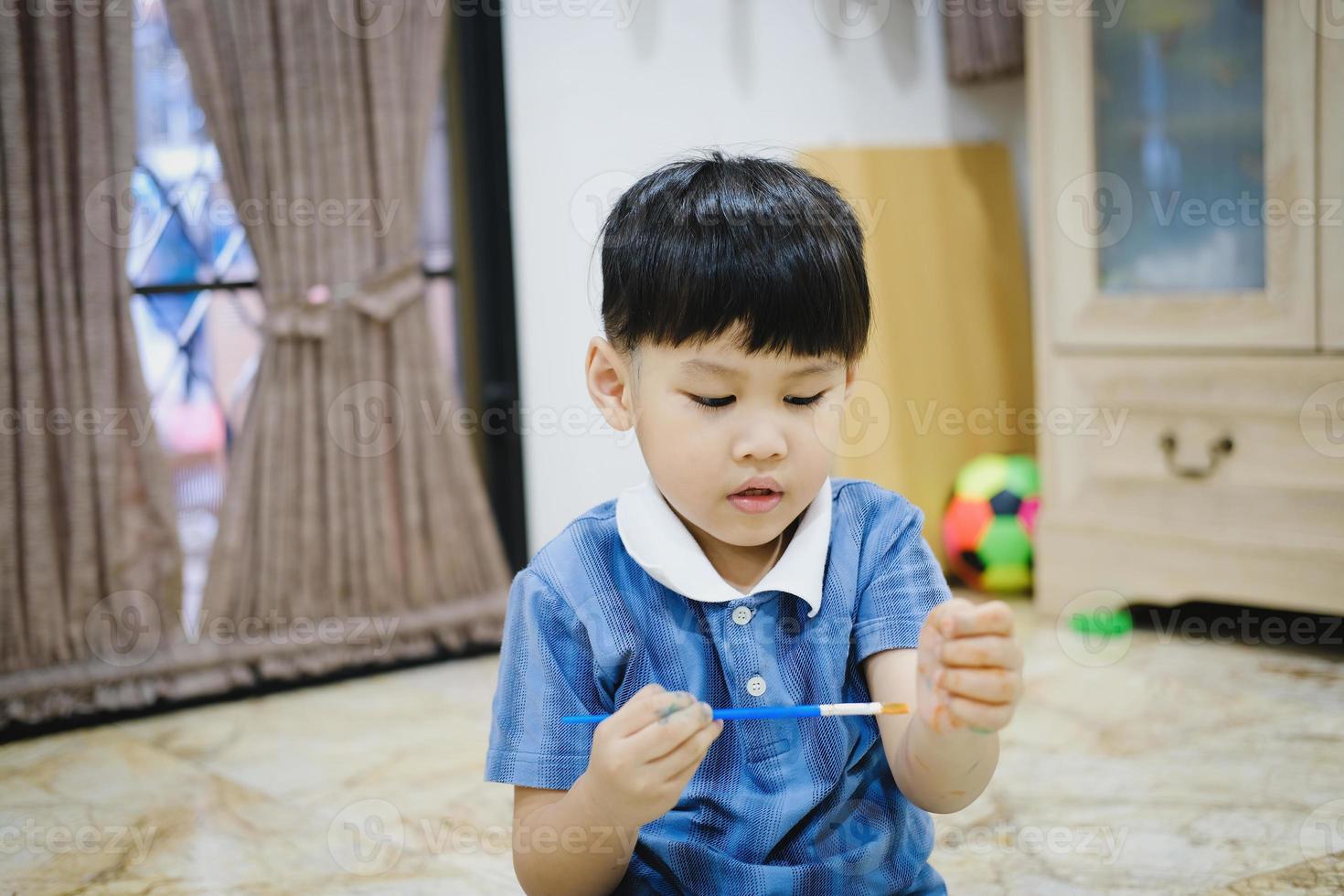 Children use watercolor brushes to draw on their arms to create imagination and enhance their learning skills. photo