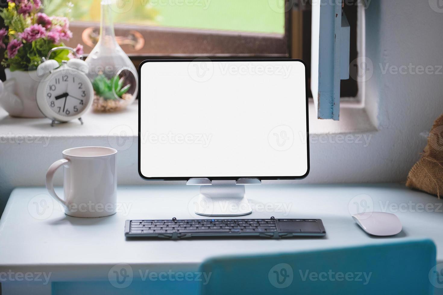 tablet for work on wood desk, a blank tablet screen can add text or other media. photo