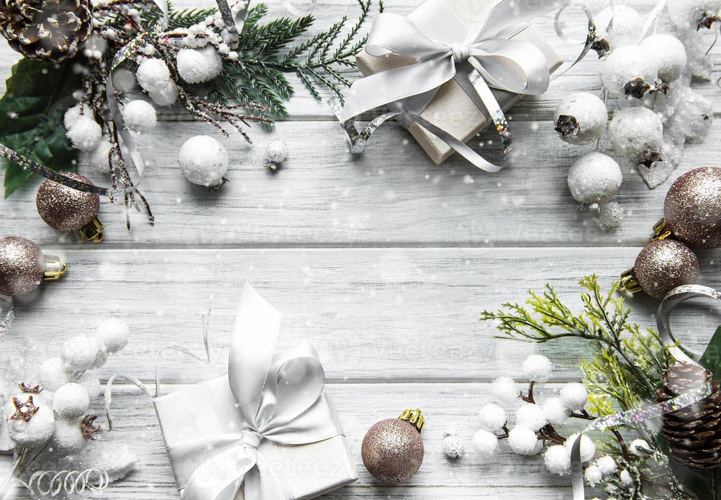 Christmas or winter composition. Frame made of  decorations on white wooden background. photo