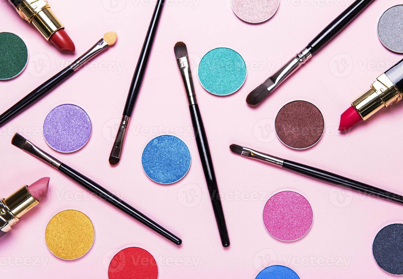 Makeup brushes and eye shadows photo