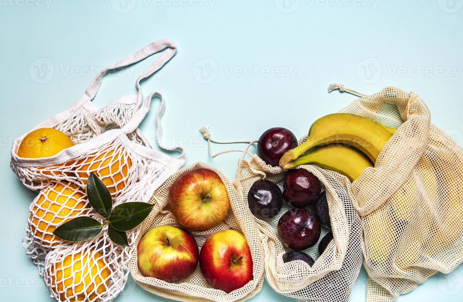 Mesh shopping bags with fruits photo