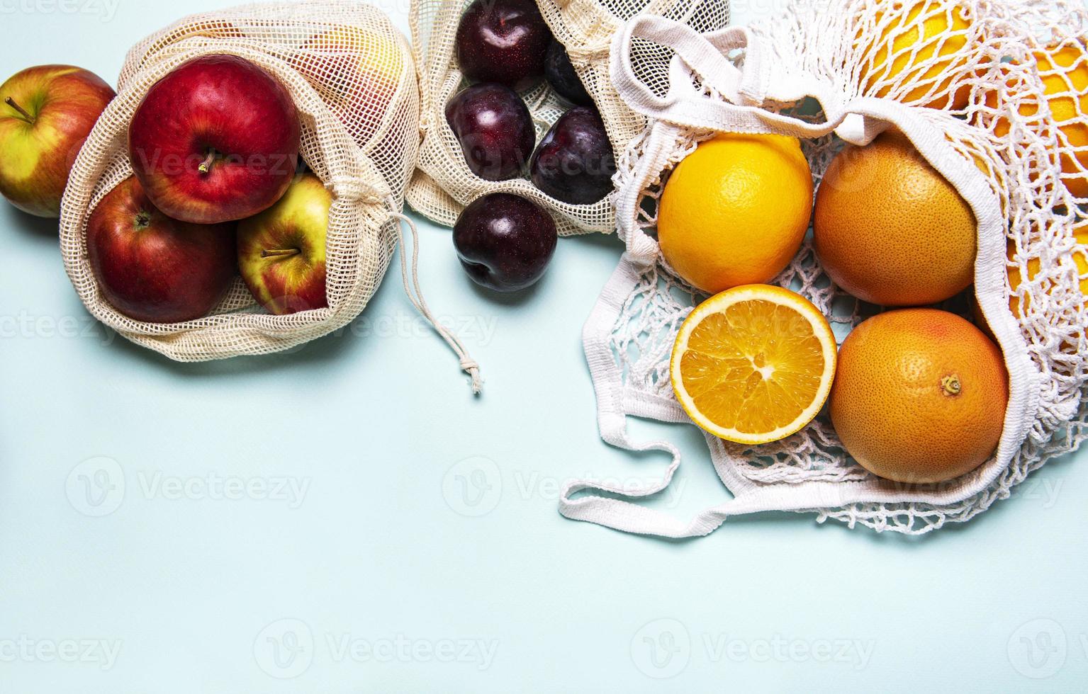 Mesh shopping bags with fruits photo