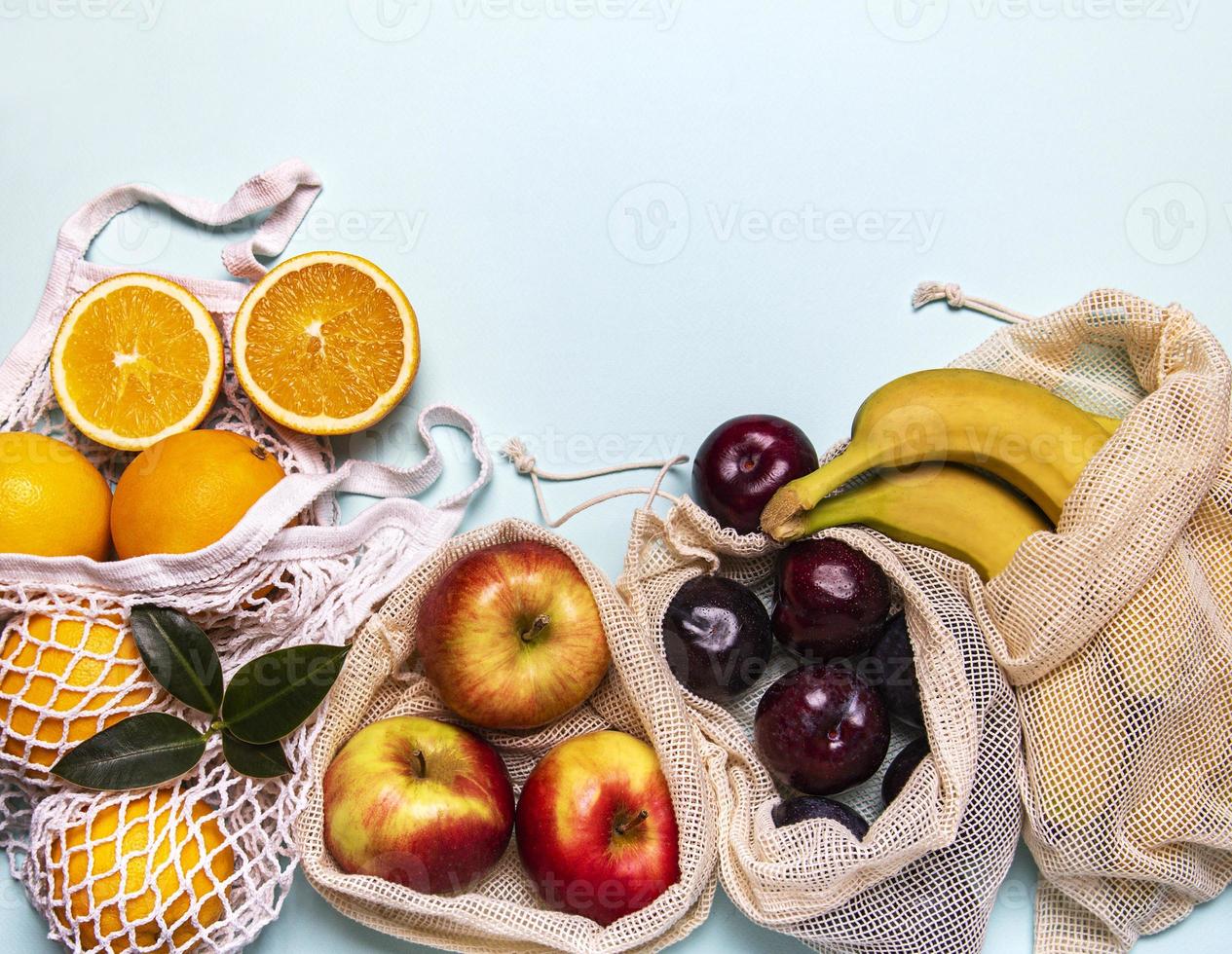 Mesh shopping bags with fruits photo