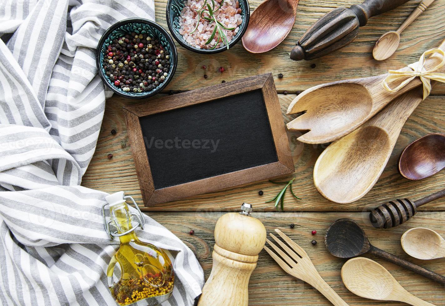 Empty chalk board and kitchen utensils photo