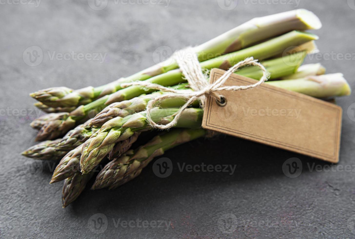 Fresh green asparagus with empty tag photo