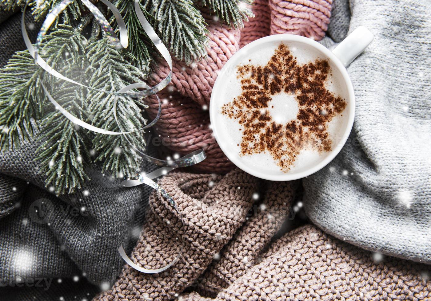 Coffee with a snowflake pattern on a warm knitted sweaters photo