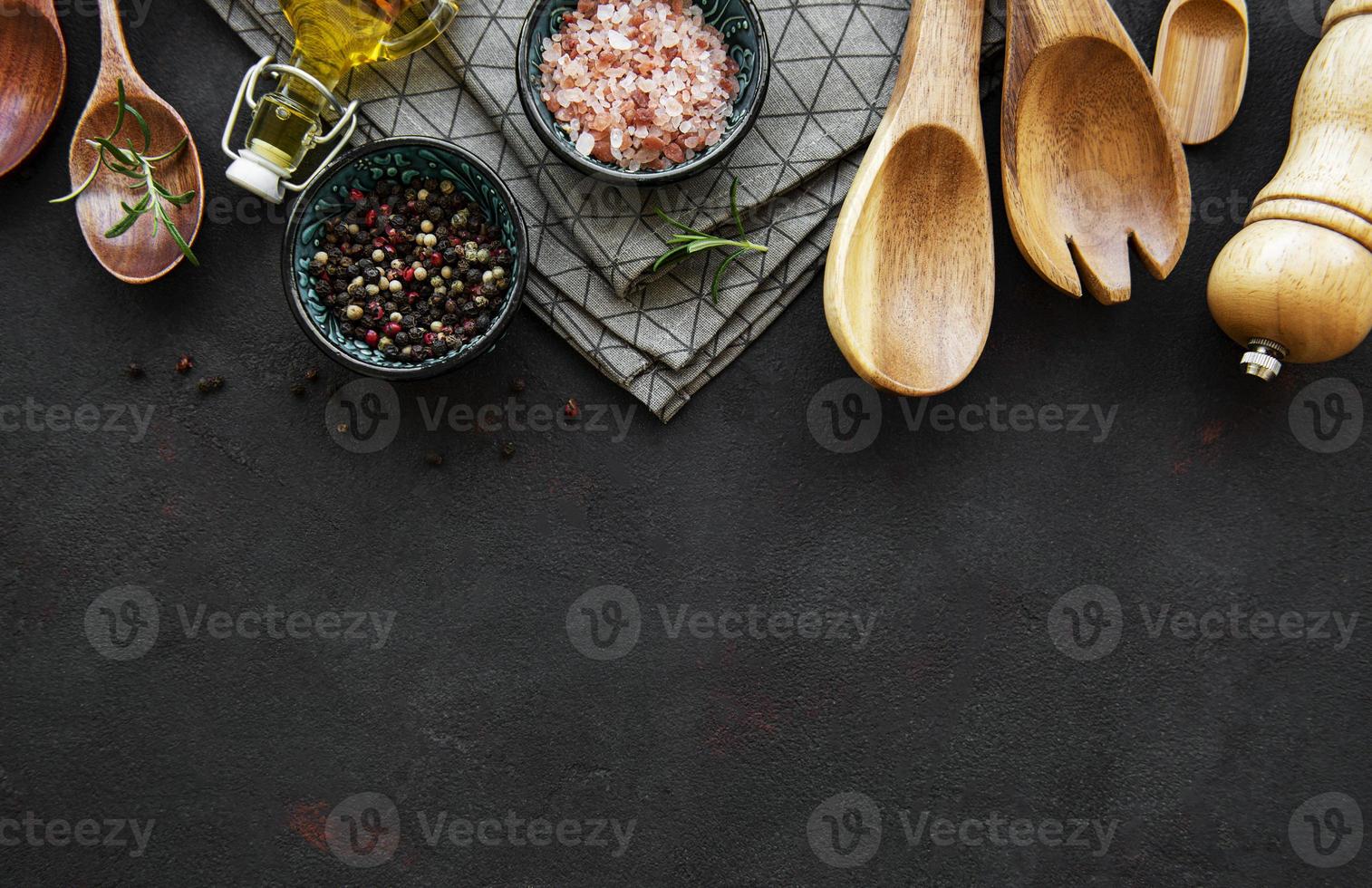 Old wooden kitchen utensils and spices as a border photo