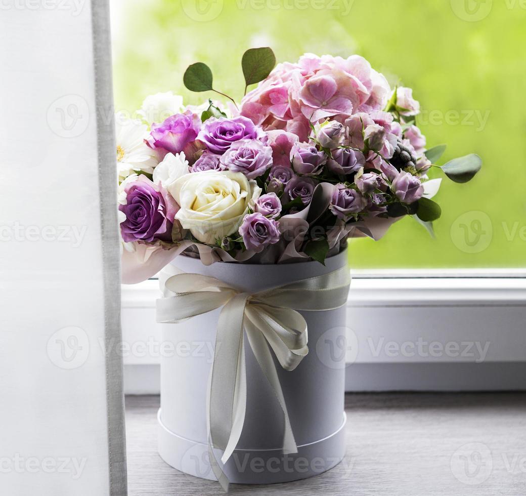 Beautiful flowers in a white round box photo