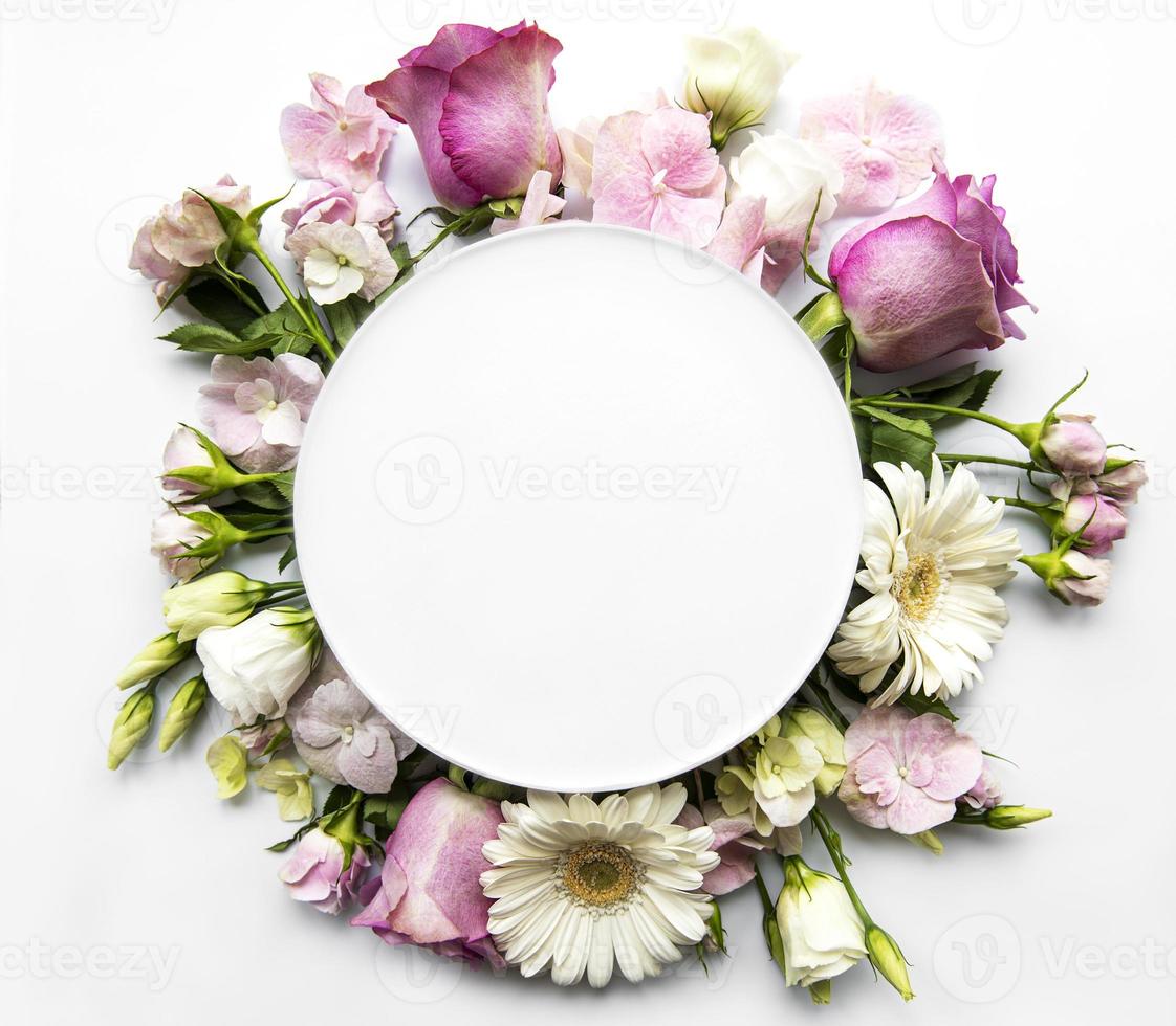 Pink flowers in round frame with white circle for text photo