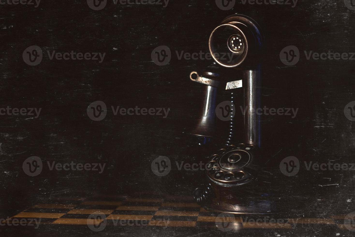 Old phone leaning on chess game. Photograph with vintage style artifacts photo