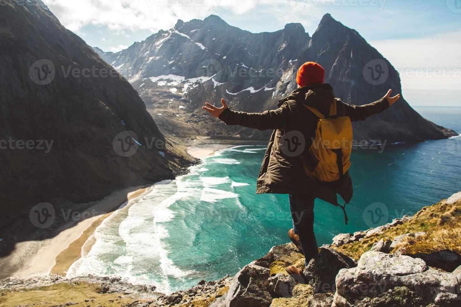 Man stand on cliff edge alone enjoying aerial view backpacking lifestyle travel adventure outdoor vacations photo