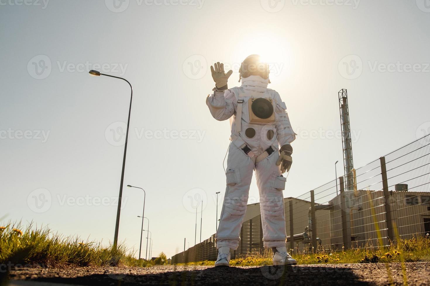 Astronaut on futuristic city background, glimpse at future photo