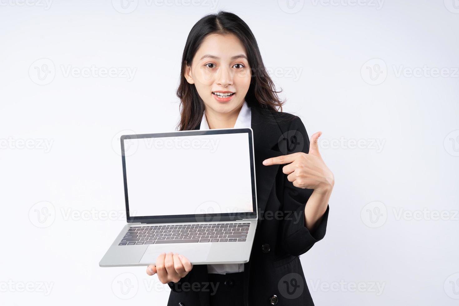 Portrait of young businesswoman wearing a suit, isolated on white background photo