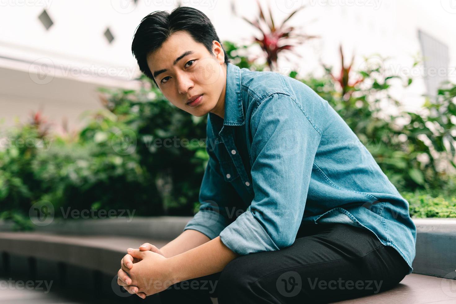 Asian handsome young man in green garden background photo