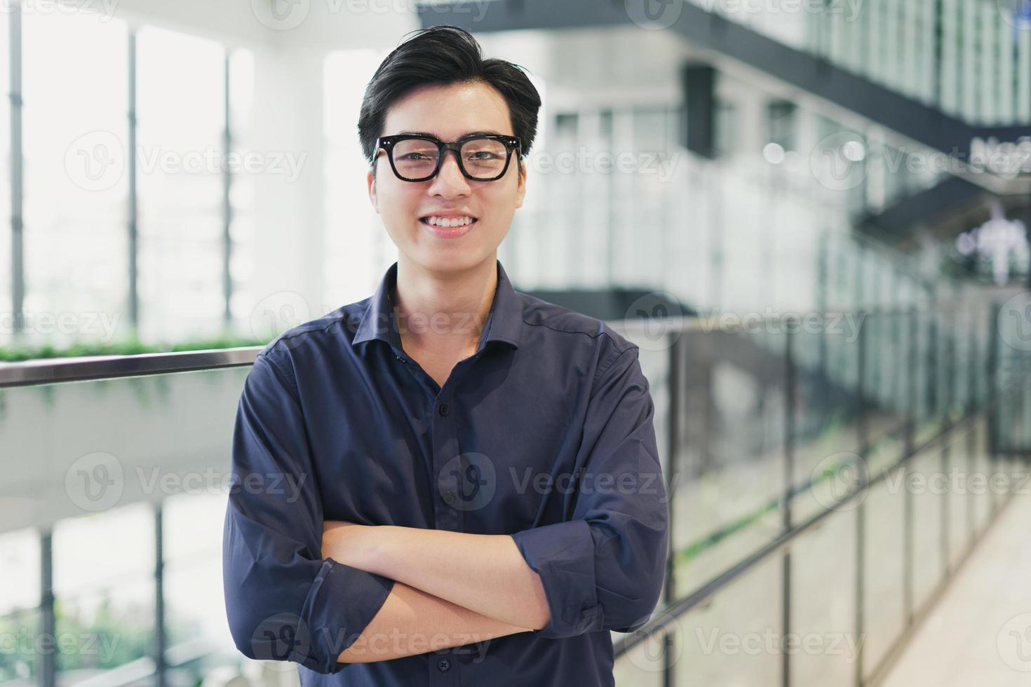 Portrait of an Asian business man, confident and smiling photo