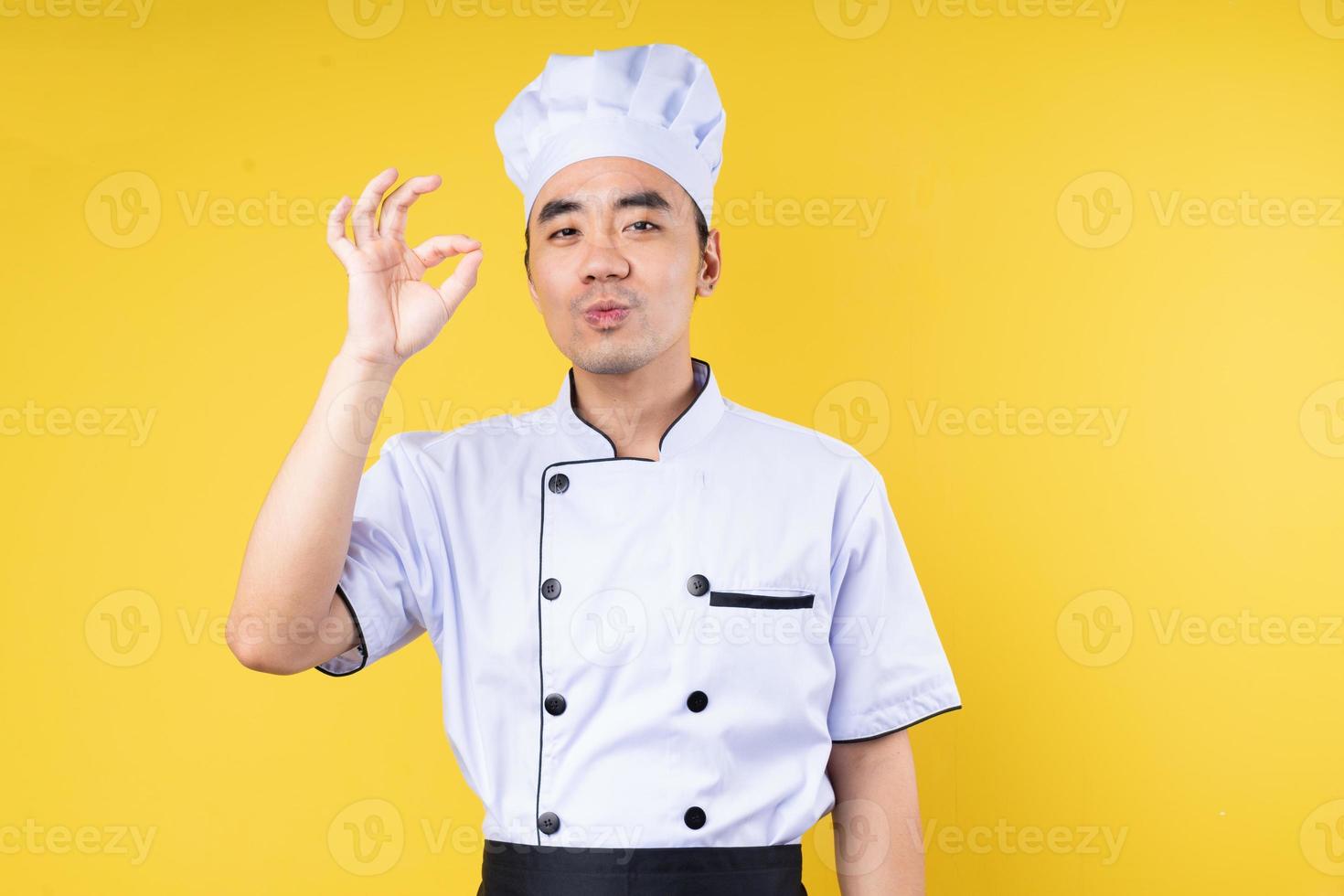 male chef portrait, isolated on yellow background photo