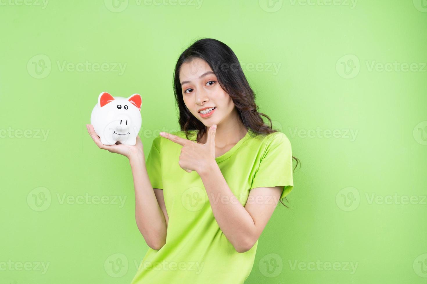 asian girl holding piggy bank in her hand money saving concept photo