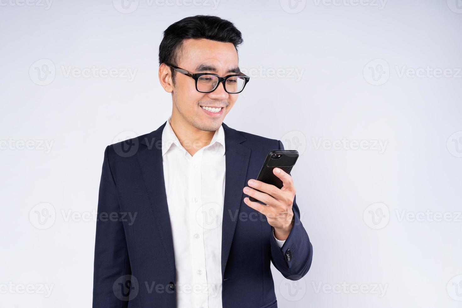 Portrait of business man wearing suit, isolated on white background photo