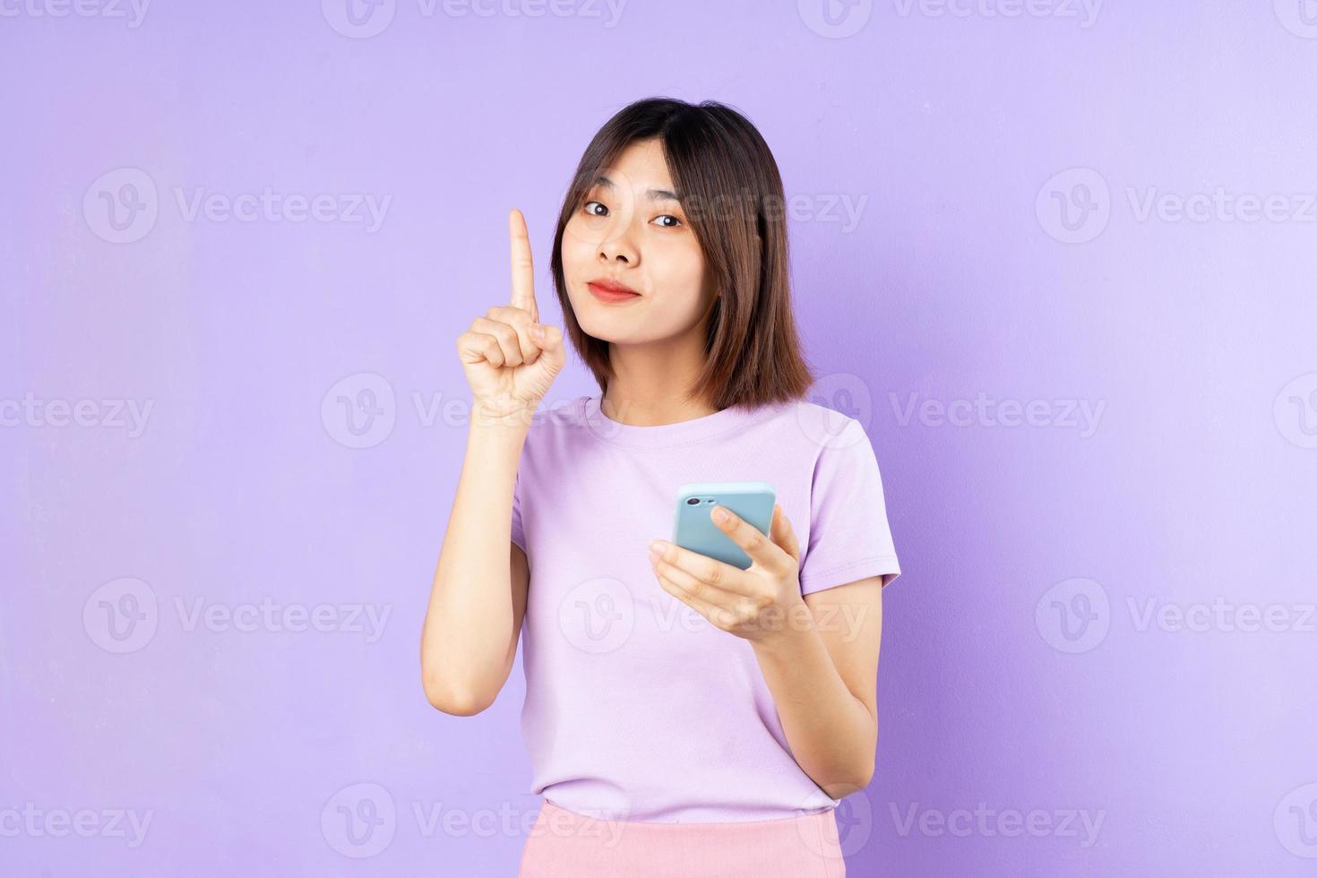 beautiful asian woman portrait, isolated on purple background photo