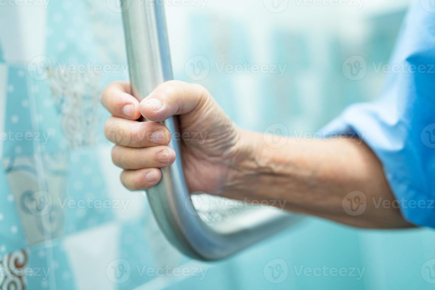 Asian senior patient use handle security with help support photo